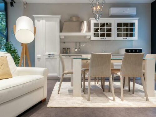 Interior of modern kitchen with dining zone and cozy armchair